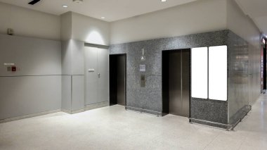Asansör kapıları ve boş reklam ekranı olan modern ofis binası, şık ışıklandırmalı temiz ve minimal ticari alan, ticari markalaşma ve kurumsal tabelalar için mükemmel