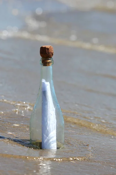 clear glass bottle with a secret message by the sea