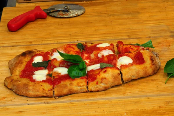pizza or Italian focaccia cooked in a wood oven with tomatoes and buffalo cheese and basil