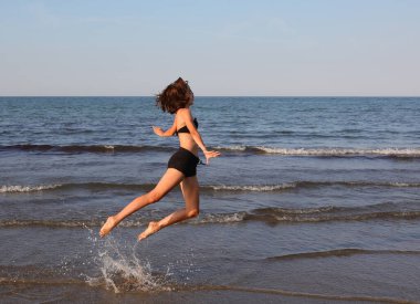 Zayıf atletik kız yazın jimnastik yapıyor.