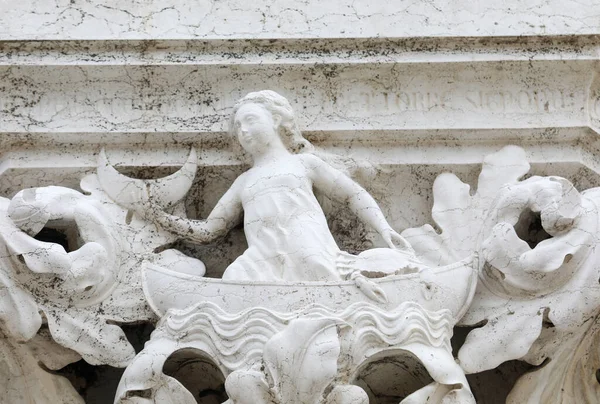 Ancient Sculpture symbolizing the creation of the Moon on a column of the Ducal Palace in Venice in Italy