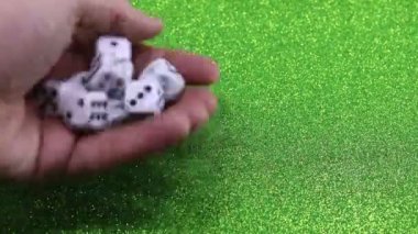 hand of man rolls the dice in the casino