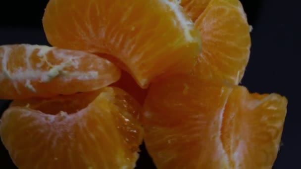 Orange Juicy Clementine Wedges Spinning Black Background — Stockvideo