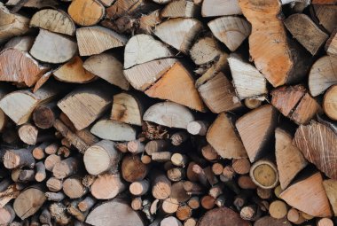 sawn logs and lumber in the woodpile to burn for warmth during the cold winter