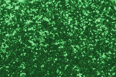 GREEN shimmering glitter material background with glowing effects and light reflections