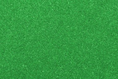 GREEN shimmering glitter material background with glowing effects and light reflections