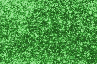 GREEN shimmering glitter material background with glowing effects and light reflections