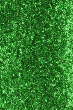 GREEN shimmering glitter material background with glowing effects and light reflections
