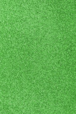 GREEN shimmering glitter material background with glowing effects and light reflections