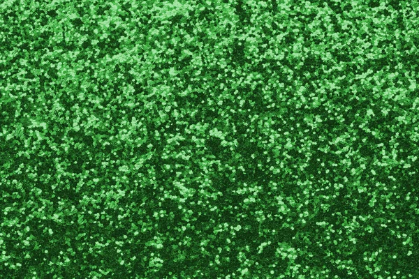 GREEN shimmering glitter material background with glowing effects and light reflections