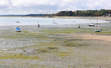 Boats stranded in the seabed during low tide in Normandy France Europe