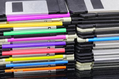 pile of old floppy disks used to save data from early personal computers in the 80s and 90s