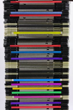 stack of many old magnetic floppy disks used to save data from the first personal computers