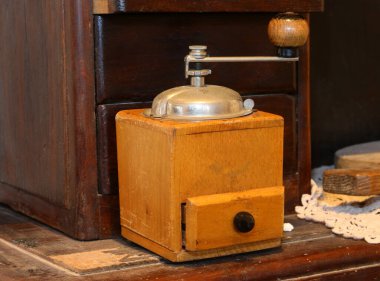 very old wooden coffee grinder to pulverize the beans and prepare the drink