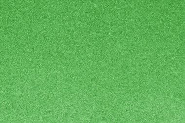 GREEN shimmering glitter material background with glowing effects and light reflections