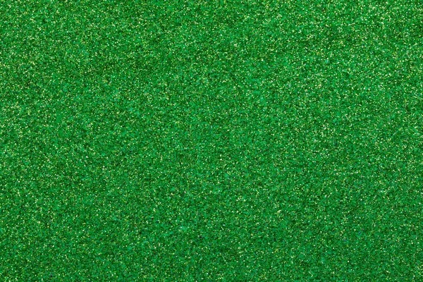 wide shimmering GREEN glitter material background with sparkles ideal as a lawn backdrop