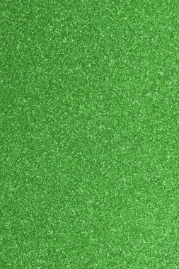 GREEN shimmering glitter material background with glowing effects