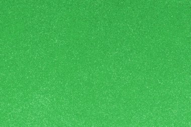 GREEN shimmering glitter material background with glowing effects