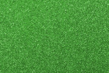 GREEN shimmering glitter material background with glowing effects and light reflections