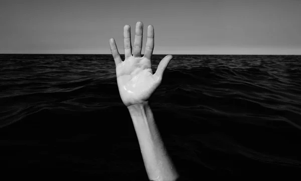 people hand while drowning and asking for help symbol of depression and failure