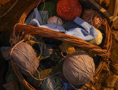 basket of balls of wool in the dark attic of an old mountain house