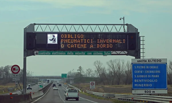 Motorway with text that means obligation winter equiment and Speed Check in Italian Language