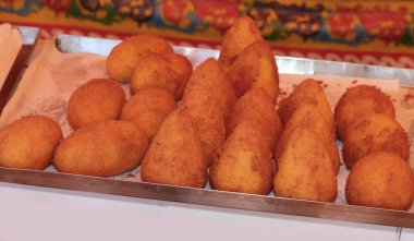 Arancini are a typical food from Southern Italy made with fried rice meatballs clipart
