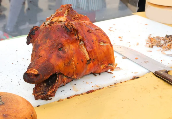 stock image head of the pork cooked called porchetta in Italian language at the butcher shop