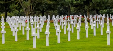 Colleville-sur-Mer, FRA, France - August 21, 2022: American Military Cemetery and many crosses on the graves of the soldiers