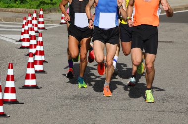 many runners during the marathon on the city streets run in sneakers