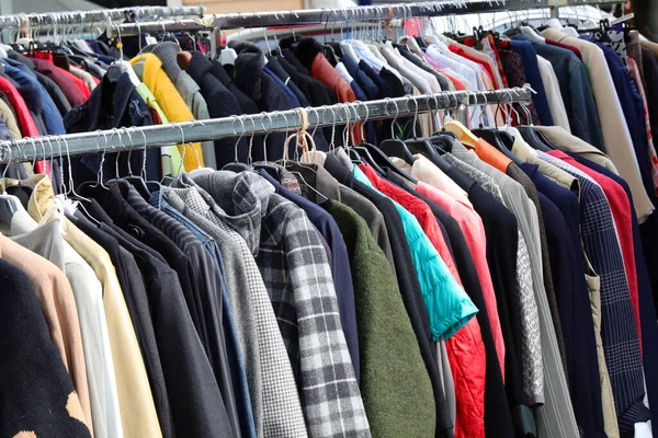 stock image vintage used clothes and new dresses in the stall at the flea market