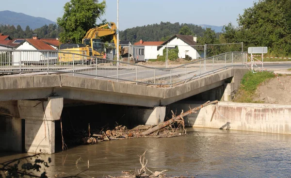 Yıkılmış köprüsü olan yol ve yıkılmış beton sütun nehre dökülüyor.