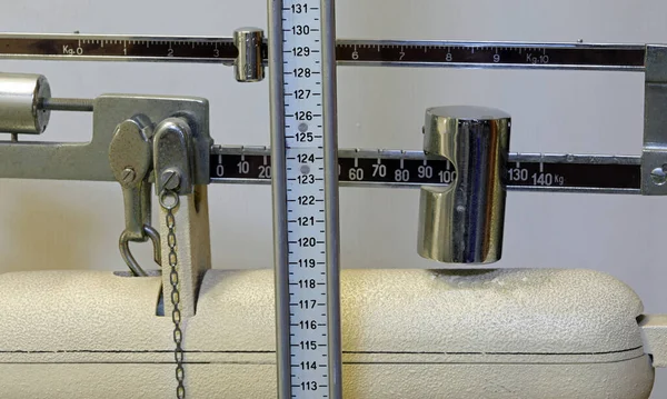 Vintage bathroom scales in the doctor s office for medical examination of children and patients with weight and measuring rod for height