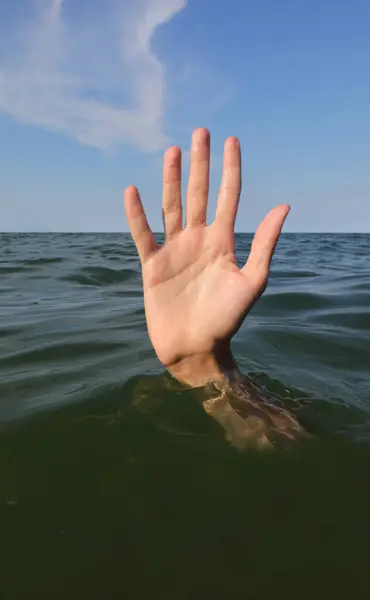 five fingers of the hand while drowning in the ocean and asking for help symbol of failure and failure