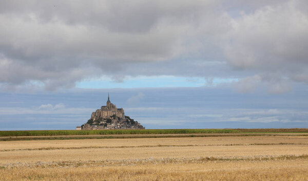 monastery of Mont Saint Michel with the Abbey church built above the hill in northern France in the Normandy region