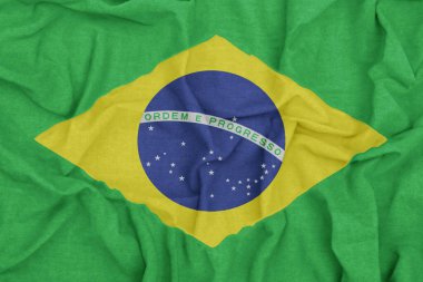 Brezilya bayrağı canlı renklere ve kumaş arkaplanına sahip