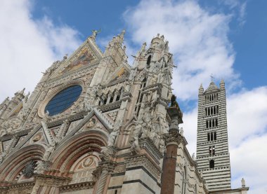 Siena Cathedral with bell tower and statua of wolf called LUPA in Central Italy