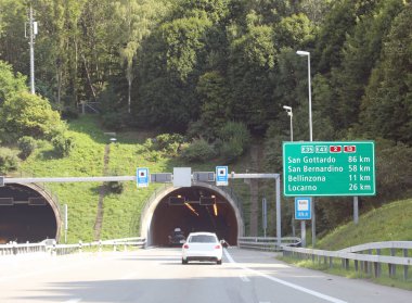 Otoyoldaki tünel ve yol işaretleri İsviçre 'deki birçok yerin yönünü gösteriyor.