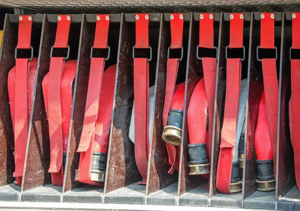 stock image many red fire hoses of firefighters placed inside the fire truck