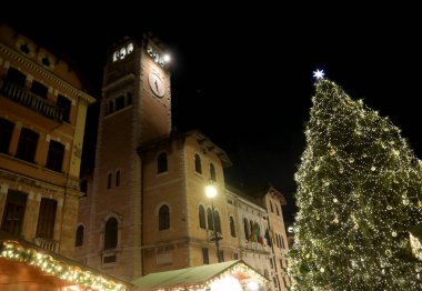 Asiago, VI, İtalya - 9 Aralık 2023: Büyük Noel Ağacı ve dağlardaki küçük kasabada ışıklar ve kamu binası