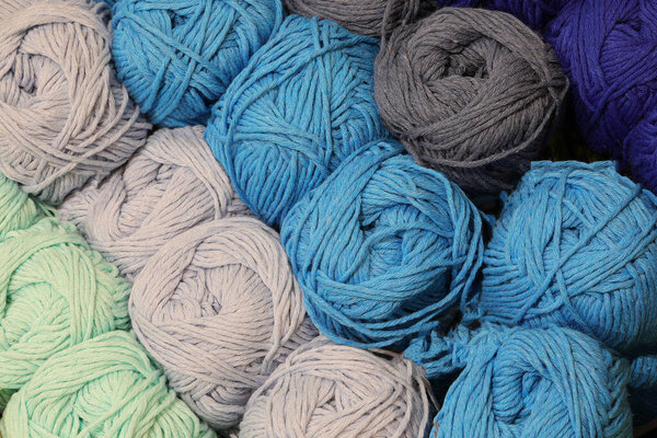 many colorful balls of cotton thread for sale in yarn shop