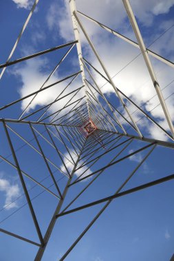High Voltage Electricity Grid Pylon seen from below  and white clouds clipart