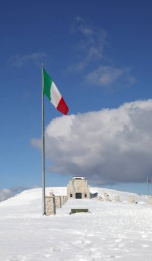 Pieve, TV, Italy - March 13, 2024: Military Memorial of Monte Grappa an ossuary of First World War and italian flag on winter clipart