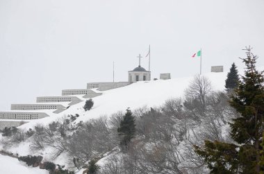 Pieve, TV, Italy - March 13, 2024: Military Memorial of Monte Grappa an ossuary with white snow clipart