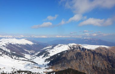 Kuzey İtalya 'daki Avrupa Alpleri' nin nefes kesici doğal manzarası. Karla kaplı dağ zirveleri ve kışın mavi gökyüzü.
