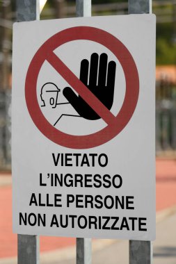 Construction site sign with the writing in Italian meaning Entry to unauthorized persons prohibited for personal safety clipart