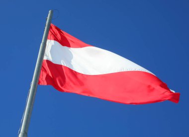 Large Austrian flag with red and white stripes waving in Austria ner the border clipart