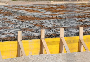 building formwork made with wooden planks during laying cement to make the foundation of the building on the construction site without workers clipart