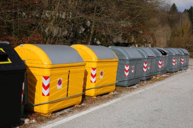 Row of many recycling dumpsters in the city clipart