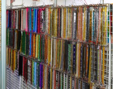 Necklace shop with lots of strands of colorful pearl necklaces in costume jewelry shop clipart